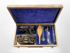 An early 20th-century violet ray generating treatment apparatus in oak box.