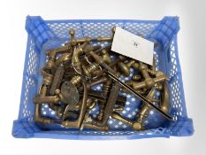 A crate of vintage brass door handles.