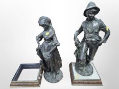A pair of cast and painted resin figures of a man and woman raised on stepped plinths, tallest 63cm.