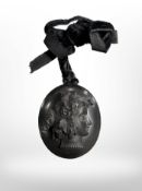 An antique jet cameo locket