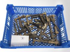 A crate of vintage brass and wooden door handles.