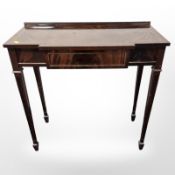 A reproduction mahogany break-front side table,