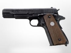 A Japanese-made die-cast metal copy of an M1911 pistol, with magazine, length 21.5cm.