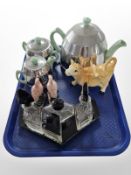 A three-piece Heatmaster tea set, together with a crystal part cruet set on stand, figure of a cow,