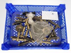 A crate of vintage brass and other door handles.