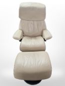 A Norwegian Ekornes Stressless cream leather swivel armchair and footstool