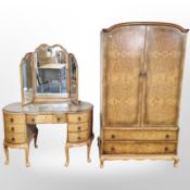 A 20th century figured walnut serpentine mirror back dressing table and matching wardrobe in Queen