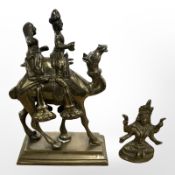 A small Indo-Tibetan cast brass temple deity, and a further eastern figure of a camel and riders,