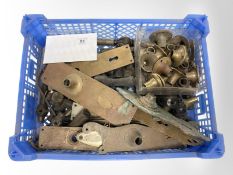 A crate of vintage brass door plates, brass fittings, etc.