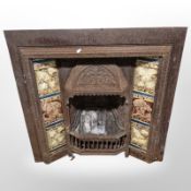 An Art Nouveau tiled cast iron fire insert, 96.5 cm x 96.