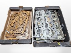 A quantity of car head gasket components.
