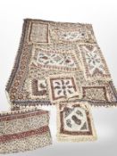 A group of Indian-style tasselled fabric throws.