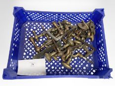 A crate of vintage brass door handles.