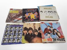 A group of vinyl LP records to include The Beatles, Queen, Eagles, Paul Simon, The Hollies, etc.