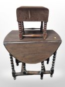 An oak barley twist gate leg table and a stool