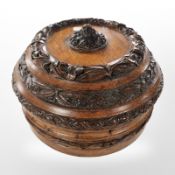 A Victorian heavily carved oak circular jewellery box, diameter 26cm.