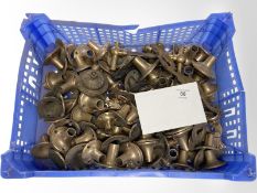 A crate of vintage brass door handle collars.