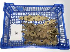 A crate of vintage brass door plates.