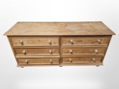 A pine six drawer low chest,