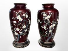 A pair of 20th century Japanese cloisonné enamel vases on wooden stands, vases 15cm.