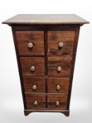 A reproduction hardwood eight drawer chest,