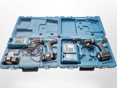 Two boxed Makita power drills.