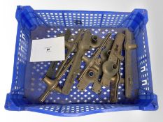 A crate of vintage brass door plates.