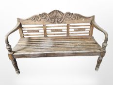 A carved teak garden bench,