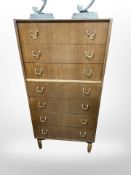 A 20th century G-plan teak seven drawer tall boy designed by E.