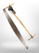 A 19th century two-man saw and an Atco lawn edging tool