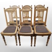 A set of 12 early 20th century oak dining chairs