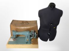 An adjustable dress maker's mannequin torso and an Alfa hand sewing machine