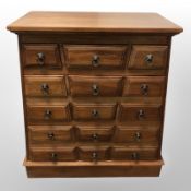 A contemporary hardwood 15 drawer chest,