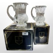 Two boxed Edinburgh Crystal jugs etched with thistles, tallest 17cm.