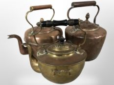 Two Victorian copper kettles, and a further brass example.