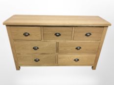 A contemporary oak seven drawer sideboard,
