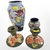 Two Moorcroft vases and a pair of squat candlesticks, tallest 18.5cm.