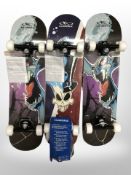 Three skateboards in retail packaging