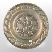 An Arts and Crafts pierced copper charger,