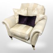 A contemporary armchair in two-tone gold fabric with three cushions retailed by Fenwicks,