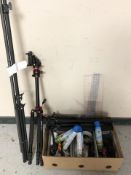 A group of telescopic tripod stands, cans of duster, fabric pins,