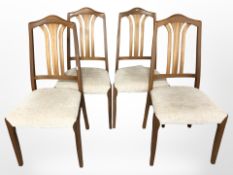A set of four contemporary teak dining chairs