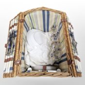 A wicker-cased picnic set.