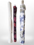 Three rolls of upholsterer's fabric / material, width approximately 140 cm, length unknown.