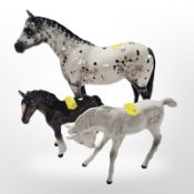A Beswick dappled horse, height 20cm (left ear restored), together with two foals.