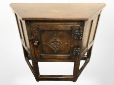 An early 20th century carved oak low cupboard,