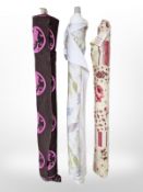 Three rolls of upholsterer's fabric / material, width approximately 140 cm, length unknown.