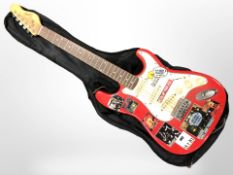 An Encore Stratocaster-style electric guitar, in carry bag.