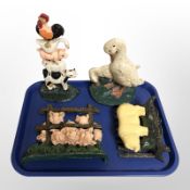 Four painted cast-iron door stops, all depicting animals.