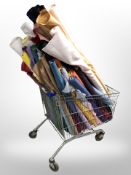 A trolley containing a very large quantity of upholsterer's material in various colours